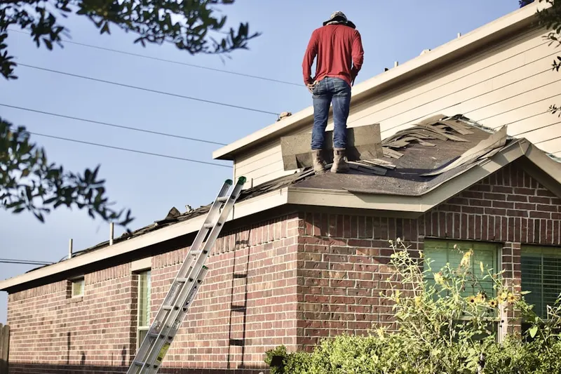Professional roofer working on a residential roof in Colesville